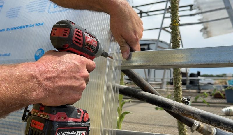 Securing a polycarbonate panel edge with an impact driver during installation